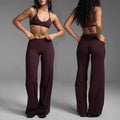 Haideyu OEM ODM custom burgundy seamless workout set dual model dynamic yoga stretch pose, thin halter sports bra + high waist flared yoga pants, soft buttery active fabric, custom color logo size service, transparent no watermark background fitness apparel photography
