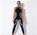 Haideyu OEM black grey color block seamless two-piece yoga set full front standing shot, racerback tank + anti-slip high waist leggings for bulk custom manufacturing orders on haideyu.com