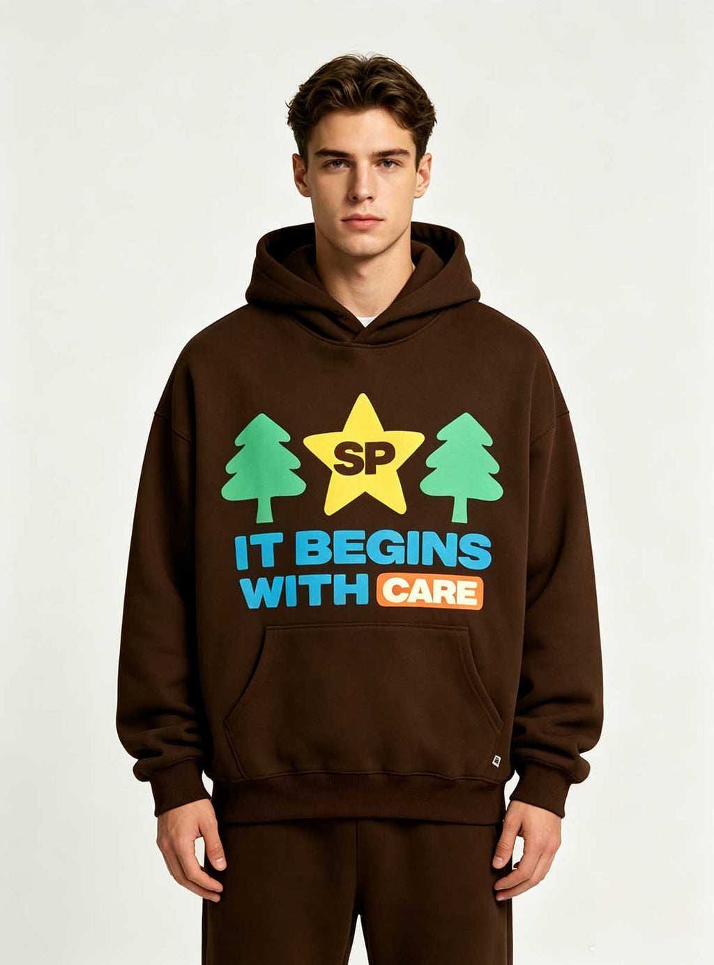 Full front standing pose of tree graphic brown hoodie on male model, soft brushed fleece casual street top for private label men’s apparel