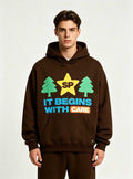 Full front standing pose of tree graphic brown hoodie on male model, soft brushed fleece casual street top for private label men’s apparel