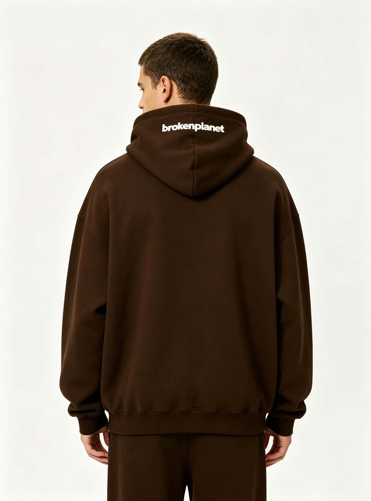 Back side profile shot of oversized pullover hoodie on male model, adjustable drawstring hood for global custom manufacturing youth casual clothing