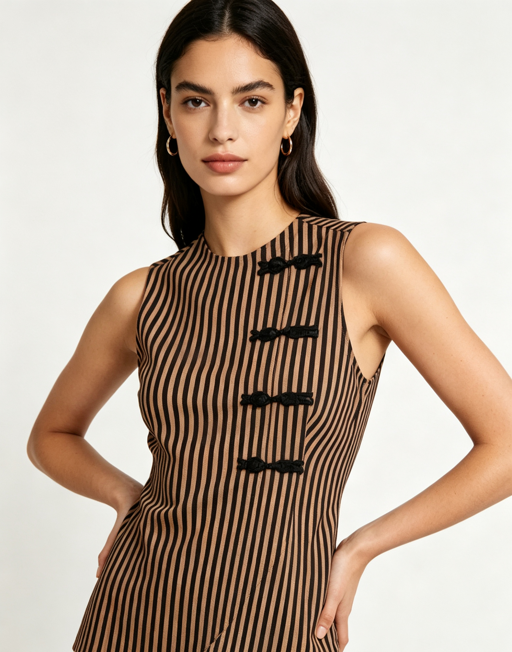 Haideyu OEM ODM striped frog-button sleeveless tailored top front view on model, neutral tone stripes with black frog closures, peplum hem for formal and casual wear