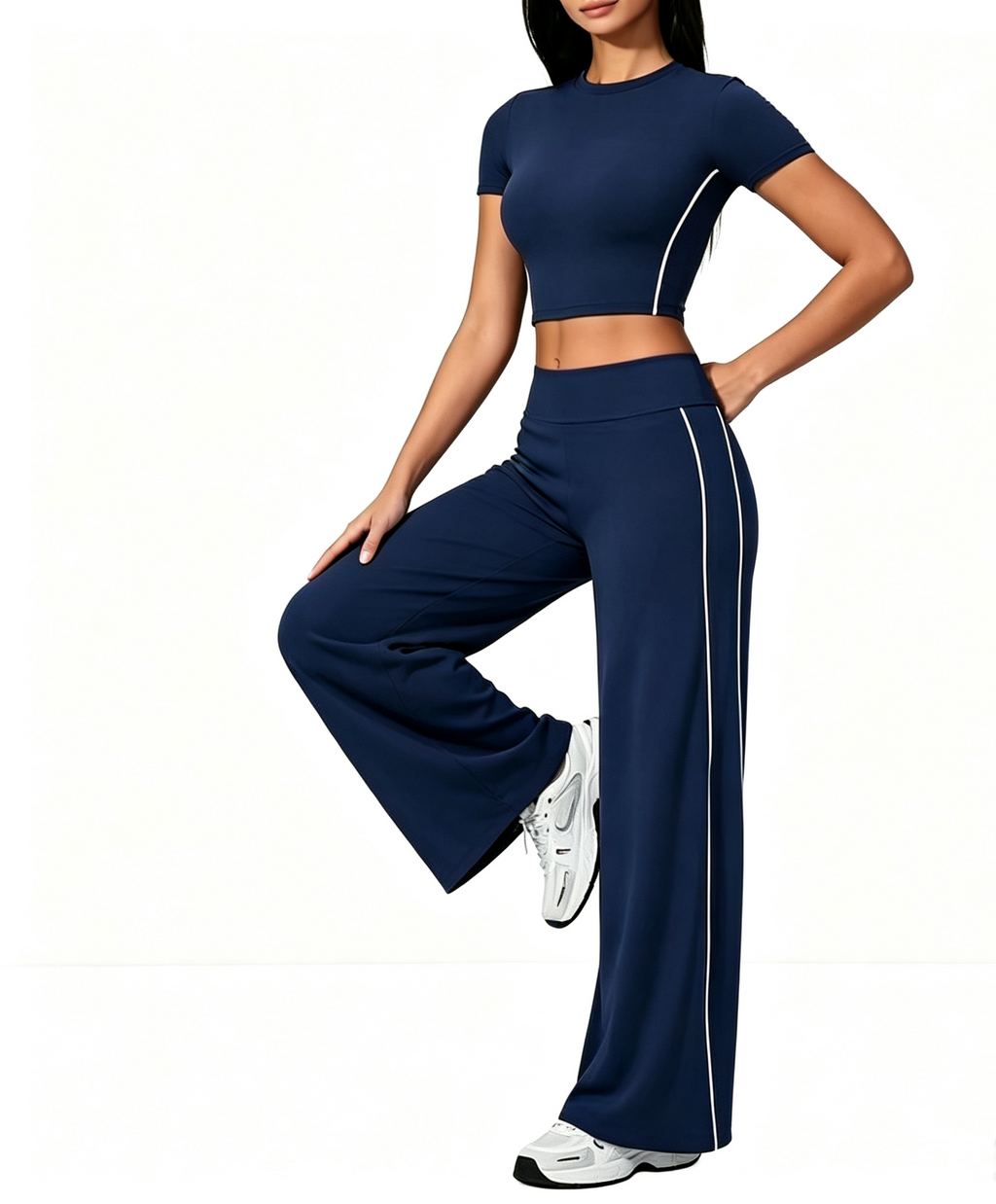 Custom Haideyu OEM ODM navy blue side striped yoga 2 piece set, nude soft stretch cropped short sleeve top, high waist wide flare leg pants, female model single leg rest pose plain white background pilates apparel