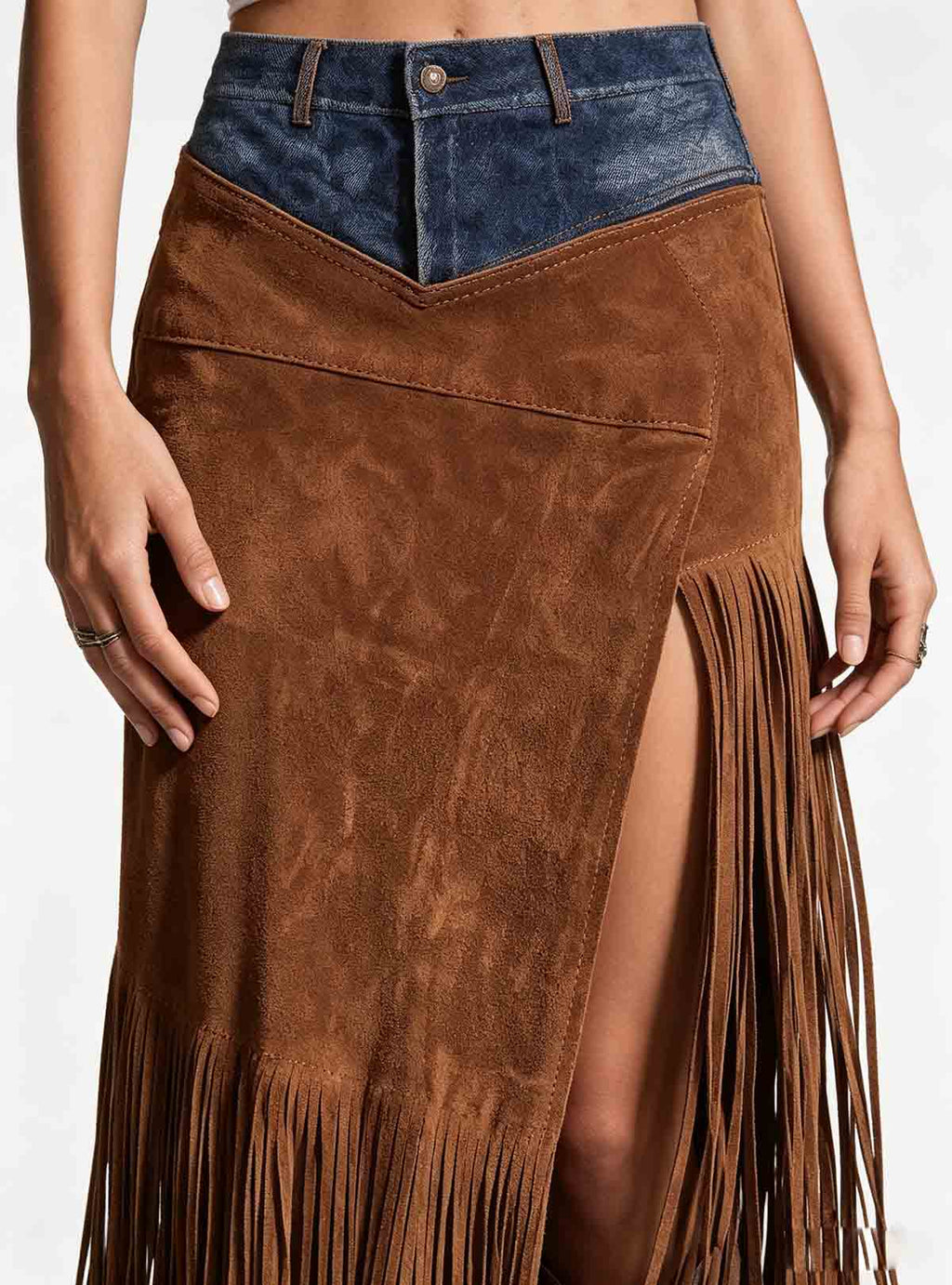 Fabric closeup of Haideyu custom western fringe maxi skirt, faux suede texture and tassel detail, denim waist splicing craft, OEM custom clothing material shot