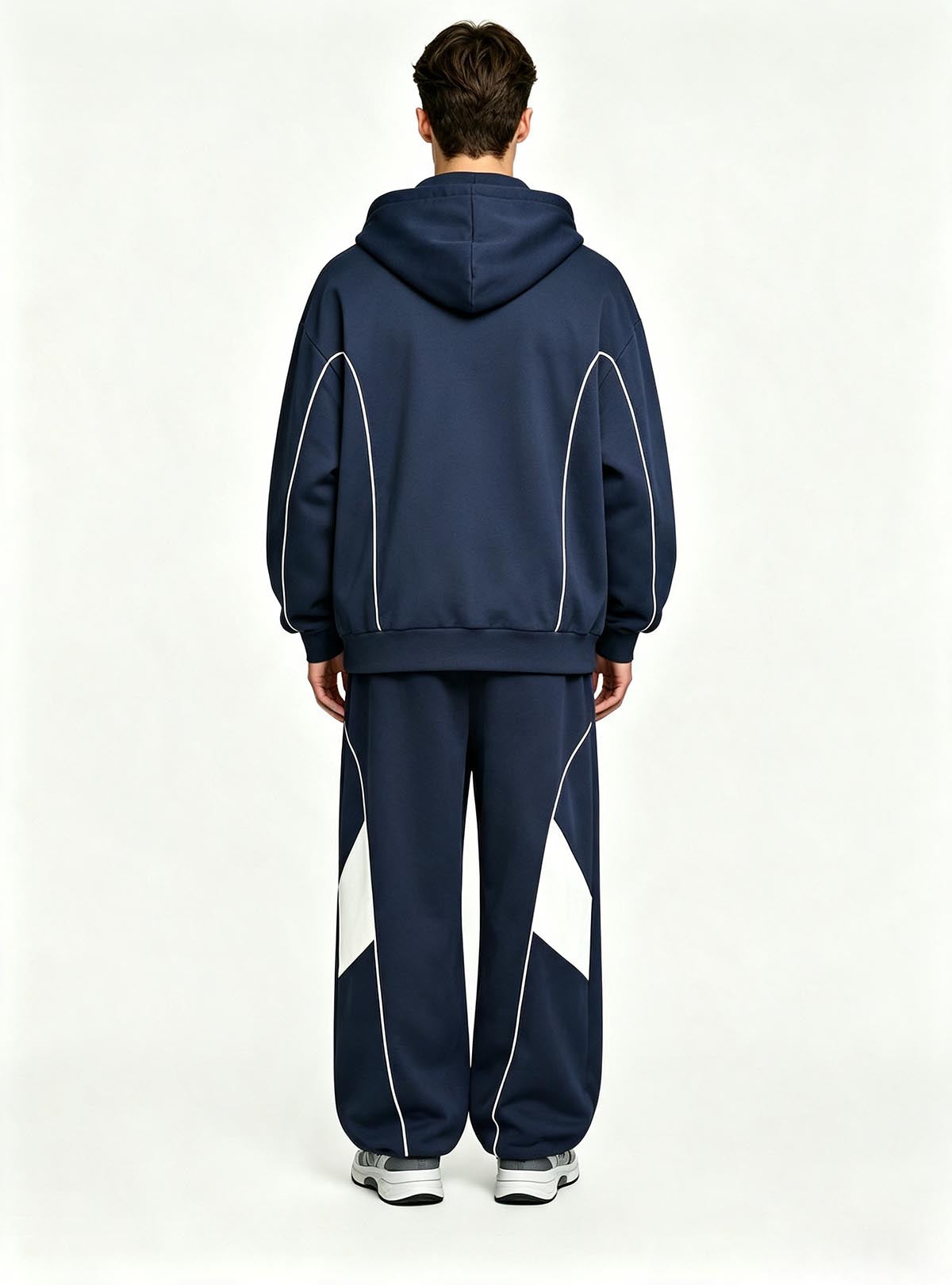 Haideyu relaxed fit men sport tracksuit, navy hooded jacket and wide‑leg pants with white geometric panel, male‑model back‑view studio shot plain white backdrop