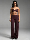 Haideyu women burgundy high waisted flared yoga leggings and halter sports bra set, 2‑piece workout activewear outfit, female model front view on solid white background