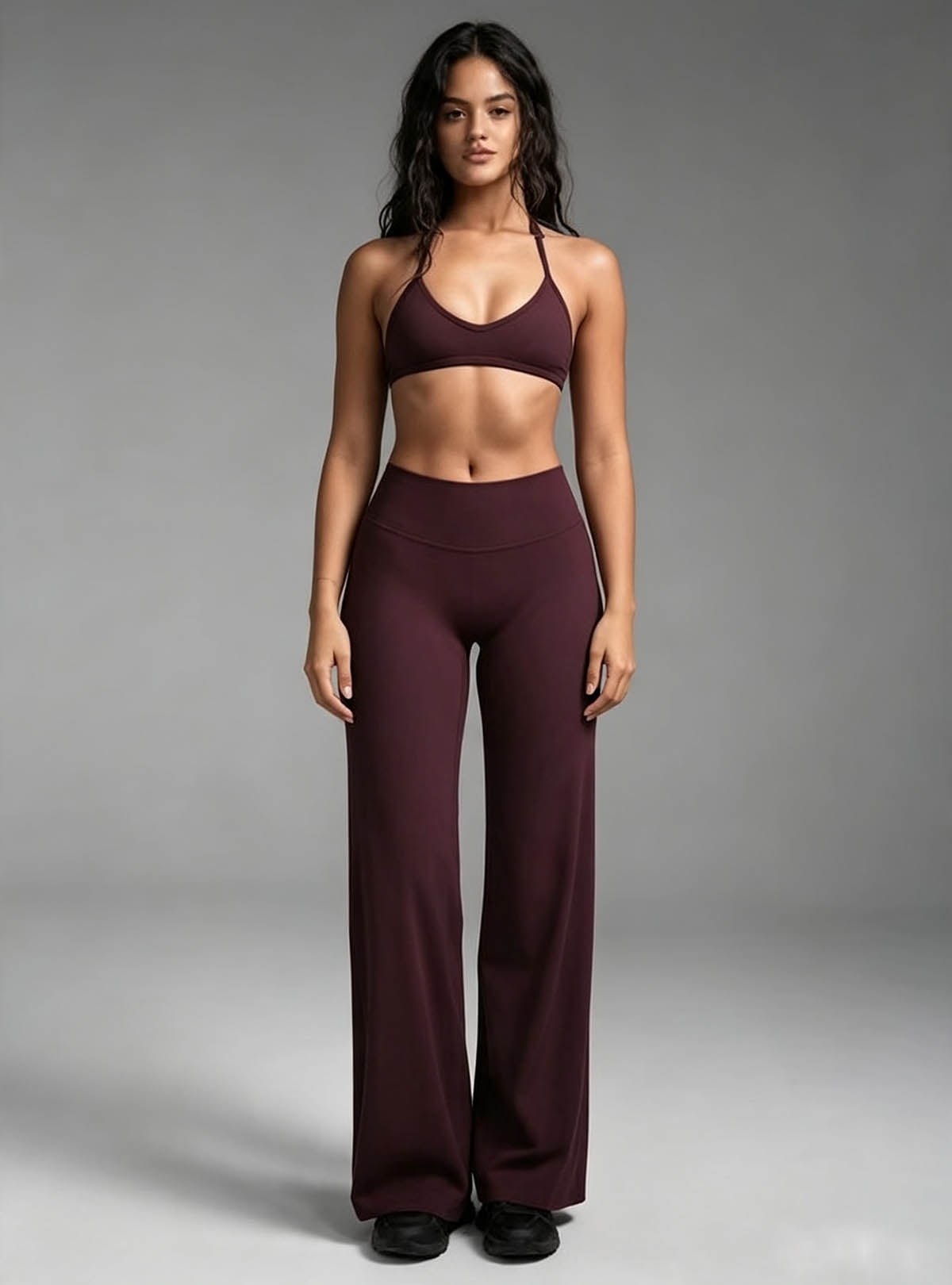 Haideyu women burgundy high waisted flared yoga leggings and halter sports bra set, 2‑piece workout activewear outfit, female model front view on solid white background