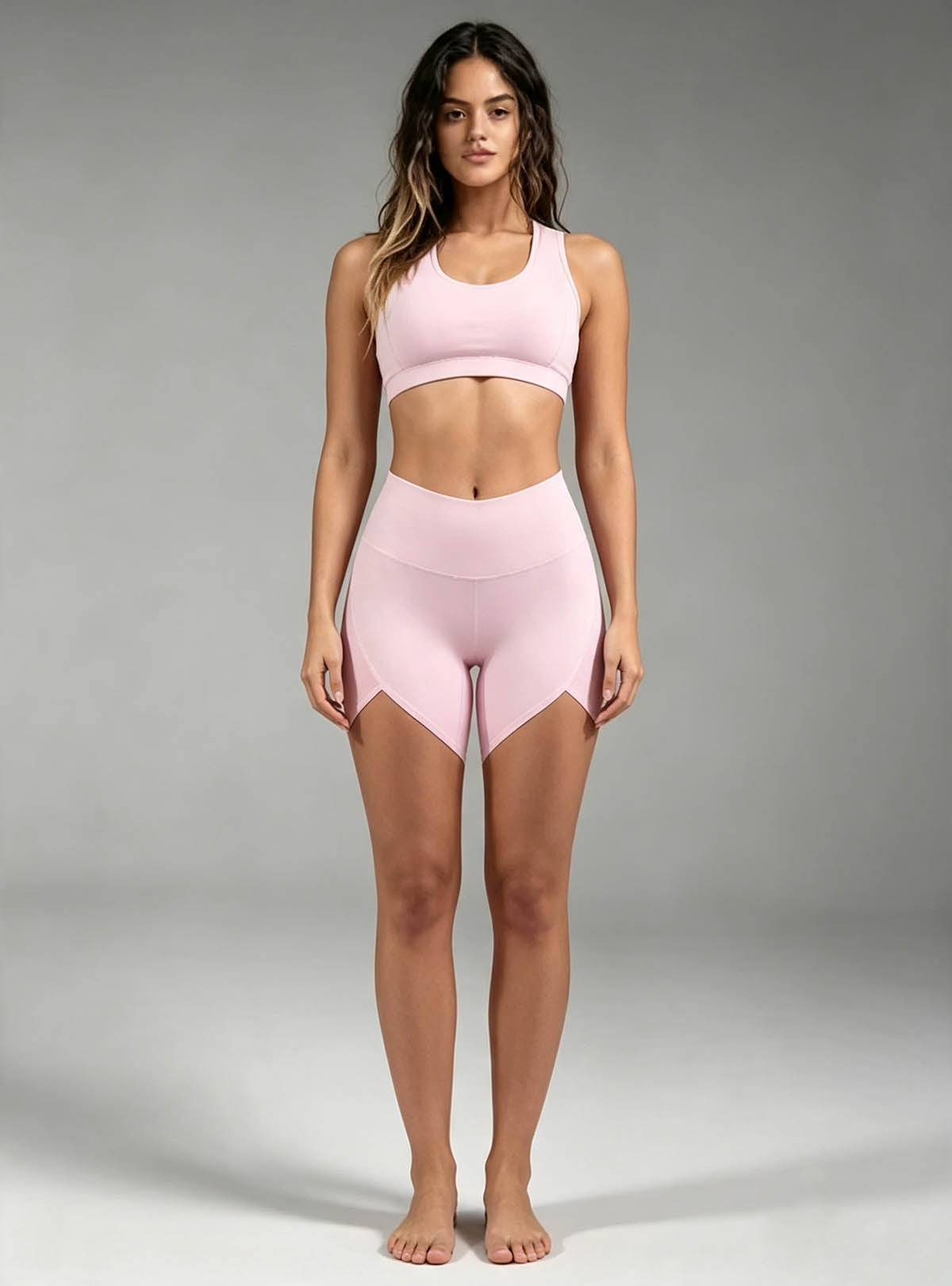 Haideyu women light pink 2‑piece activewear set, racerback sports bra and high‑waist yoga biker shorts, female model full‑body front shot on gradient grey studio background